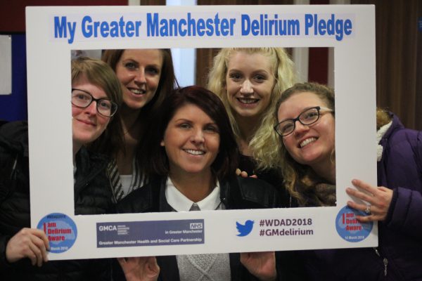 Schoolchildren holding up a frame saying My Greater Manchester Delirium Pledge