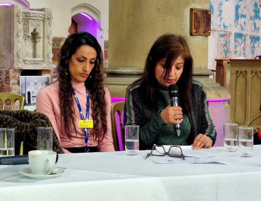 Jag Brar-Orgill with Karan Jutlla, sitting at a desk at the event