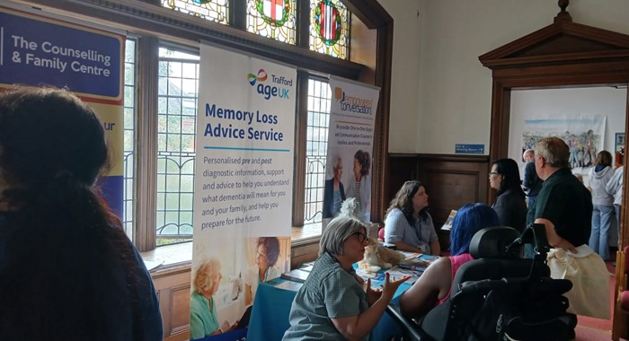 A group of people sitting together in a hall talking